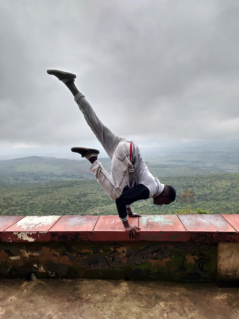 Young man practising yoga near the Rift Valley escarpment